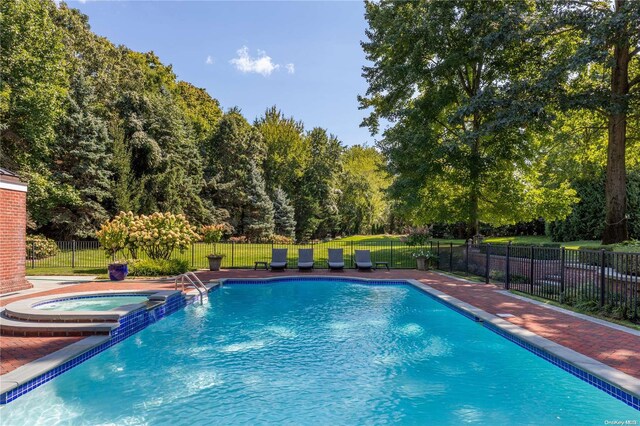 11 Dupont Ct, Brookville, NY 11548 - view of pool featuring a pool with connected hot tub and view of scattered trees