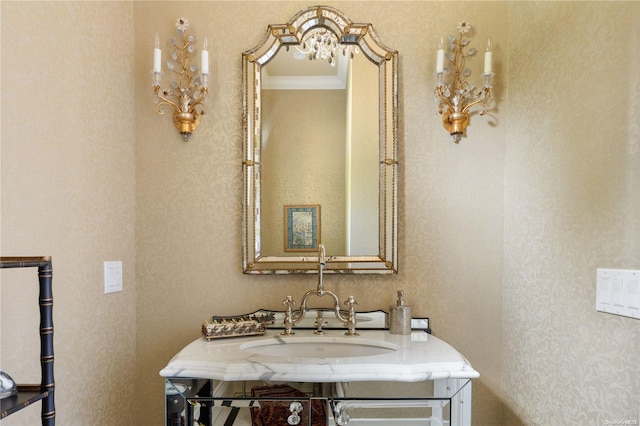 bathroom with sink and ornamental molding