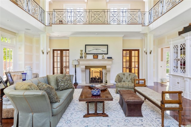 living room with a wealth of natural light, french doors, and a towering ceiling