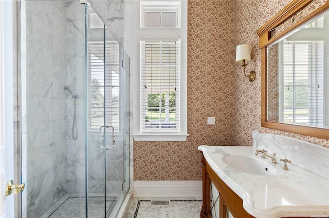 11 Dupont Ct, Brookville, NY 11548 - bathroom featuring wallpapered walls, a marble finish shower, vanity, healthy amount of natural light, and tile patterned flooring