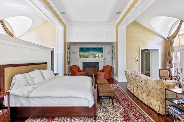 bedroom with dark wood-type flooring, lofted ceiling, and ornamental molding