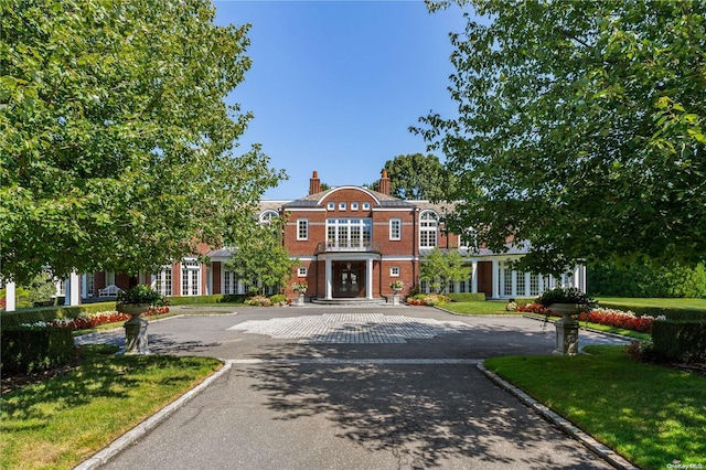 11 Dupont Ct, Brookville, NY 11548 - view of front facade with french doors, a chimney, and a front yard