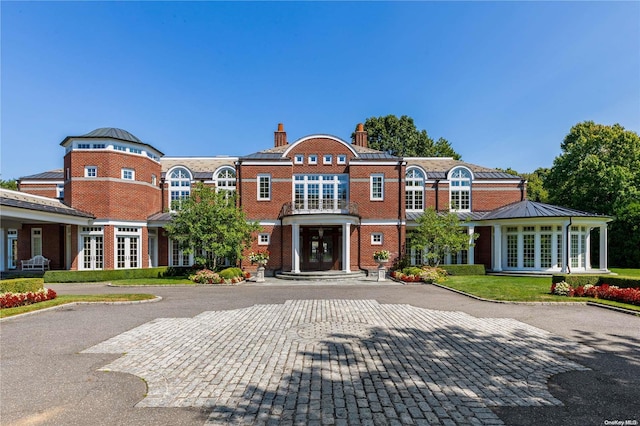 11 Dupont Ct, Brookville, NY 11548 - view of front of house featuring french doors, a chimney, and brick siding