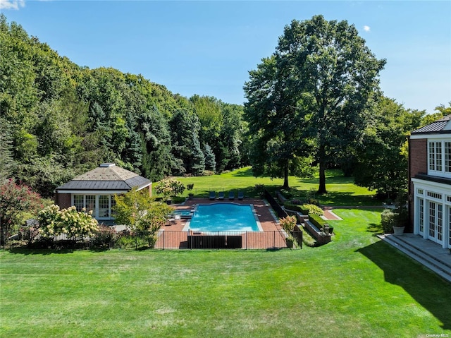 11 Dupont Ct, Brookville, NY 11548 - outdoor pool with french doors, a lawn, a wooded view, and a patio area