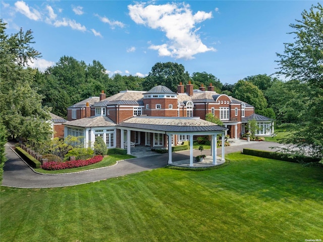 11 Dupont Ct, Brookville, NY 11548 - back of property with a chimney, a yard, a standing seam roof, and a metal roof