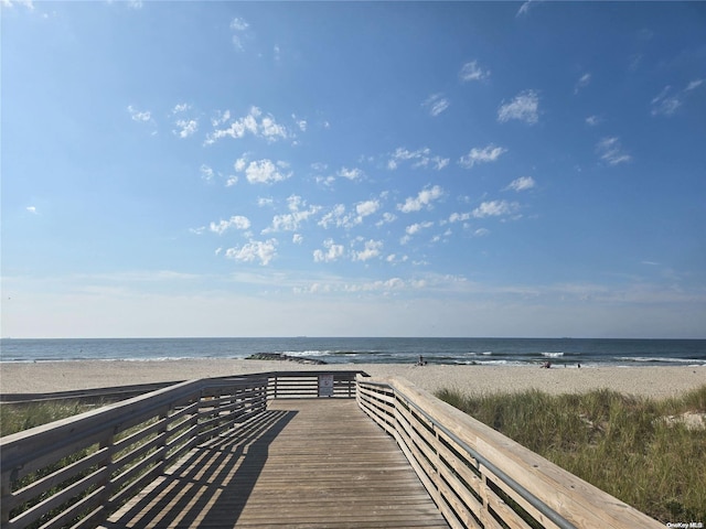 view of property's community featuring a water view and a view of the beach