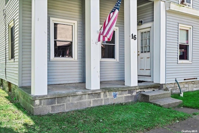 view of exterior entry with a porch