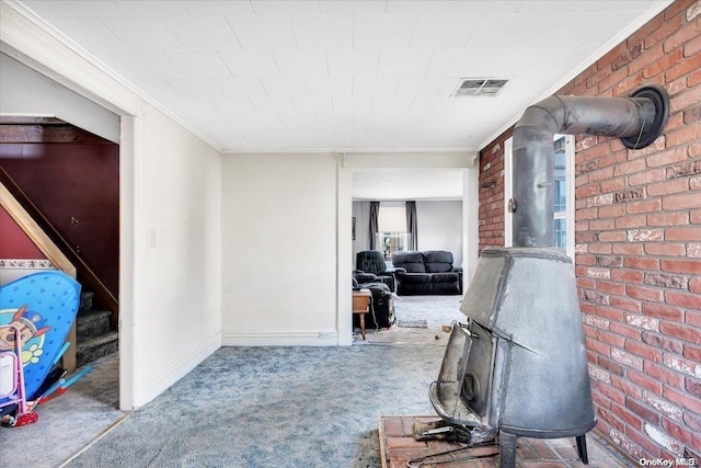 interior space with crown molding, carpet, and brick wall