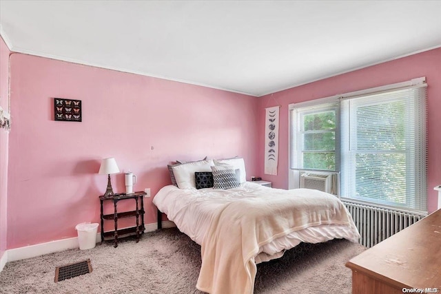 carpeted bedroom with cooling unit, crown molding, and radiator