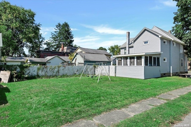 view of yard with a sunroom and a playground