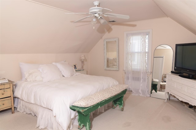 bedroom featuring carpet, visible vents, vaulted ceiling, and ceiling fan