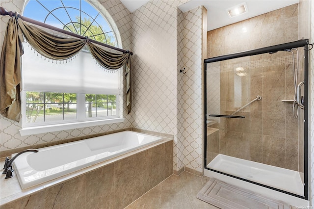 bathroom featuring tile patterned floors and independent shower and bath