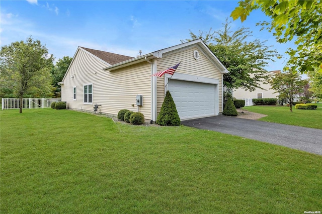 view of side of property featuring a yard and a garage