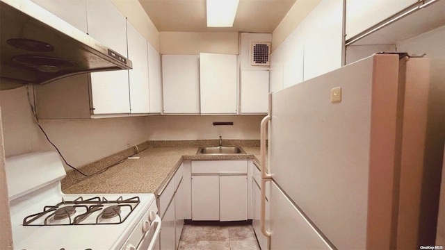 kitchen with sink, white cabinets, and white appliances