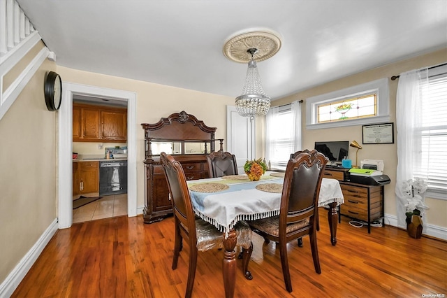 dining room featuring dark hardwood / wood-style flooring and an inviting chandelier