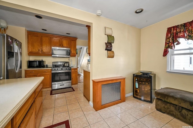 kitchen with stainless steel appliances and light tile patterned flooring