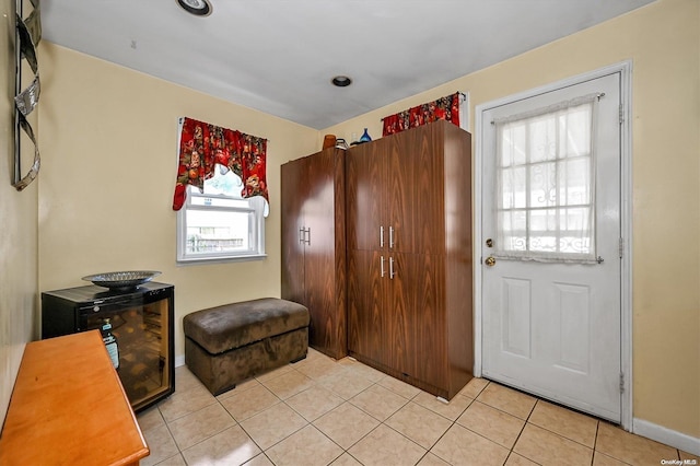 entryway with light tile patterned floors and a wealth of natural light