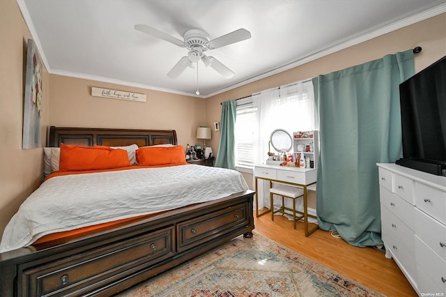 bedroom featuring ceiling fan, light hardwood / wood-style floors, and ornamental molding