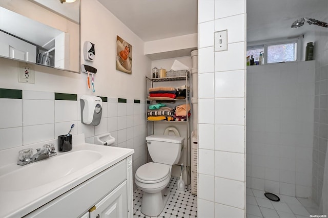 bathroom featuring curtained shower, tile patterned flooring, toilet, vanity, and tile walls