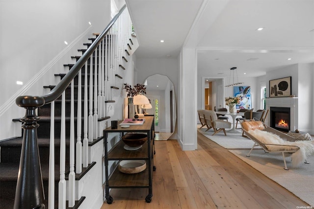 staircase with hardwood / wood-style flooring and a healthy amount of sunlight