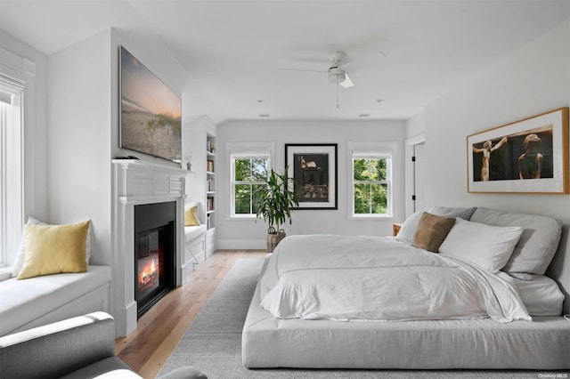 bedroom with ceiling fan and light hardwood / wood-style flooring