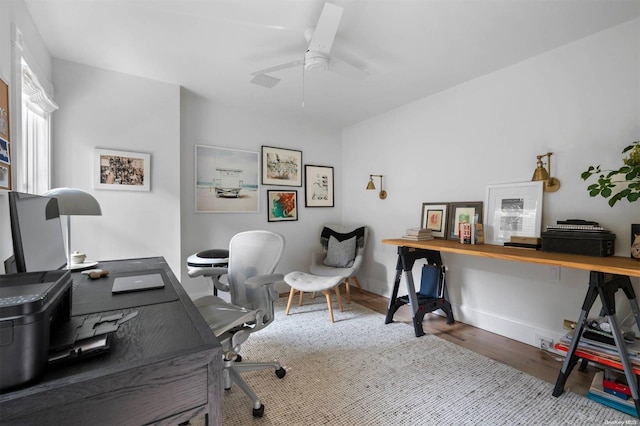 home office with wood-type flooring and ceiling fan