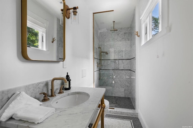 bathroom featuring tiled shower, vanity, and toilet