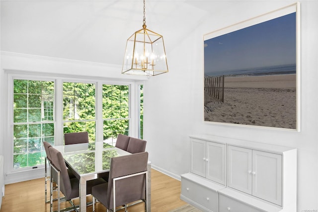 dining room featuring a wealth of natural light, light hardwood / wood-style flooring, and an inviting chandelier