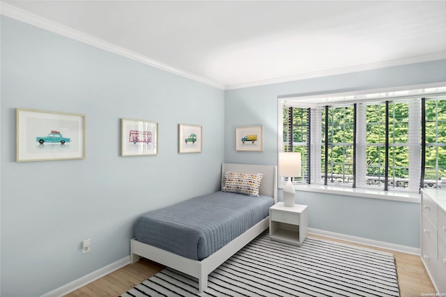 bedroom with crown molding and light hardwood / wood-style flooring