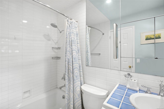 full bathroom featuring sink, shower / bathtub combination with curtain, backsplash, toilet, and tile walls