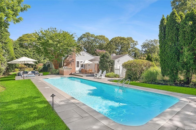 view of swimming pool featuring a patio area and a lawn