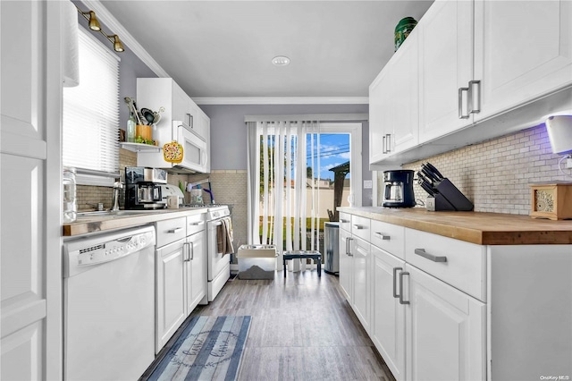 kitchen featuring butcher block countertops, white cabinetry, and white appliances