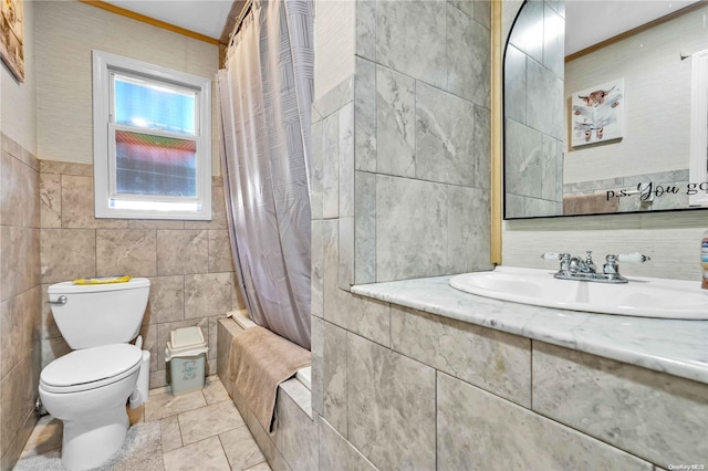 full bathroom with shower / tub combo with curtain, sink, tile walls, and toilet