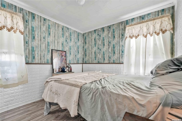 bedroom featuring hardwood / wood-style floors and ornamental molding