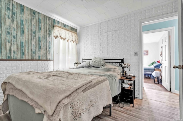 bedroom featuring hardwood / wood-style floors and ornamental molding