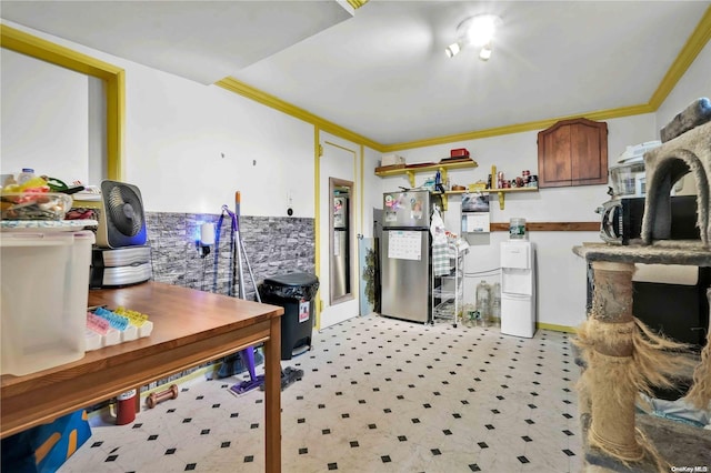 kitchen featuring stainless steel refrigerator and ornamental molding