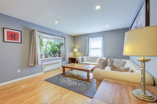 living room with light wood-type flooring and radiator