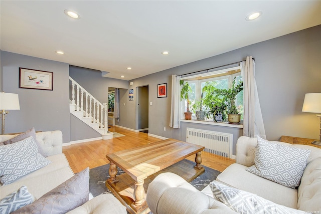 living room with radiator and hardwood / wood-style flooring