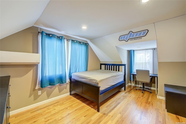 bedroom featuring hardwood / wood-style floors and vaulted ceiling