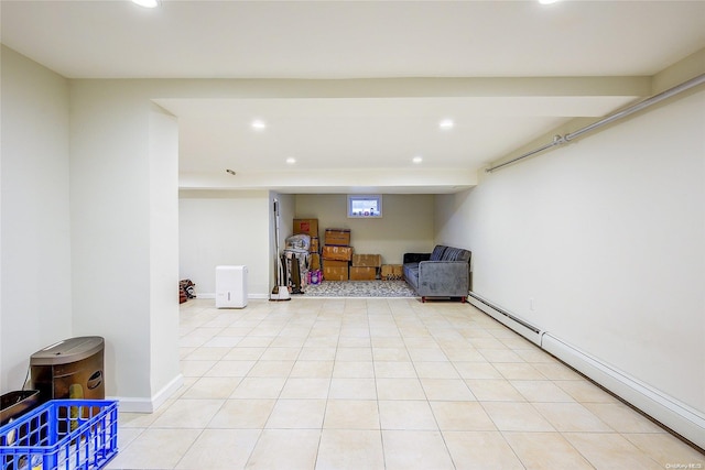 sitting room with a baseboard heating unit and light tile patterned flooring