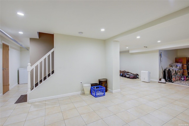 basement featuring light tile patterned floors