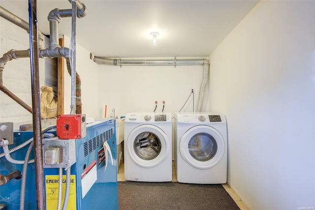 clothes washing area featuring separate washer and dryer and dark carpet