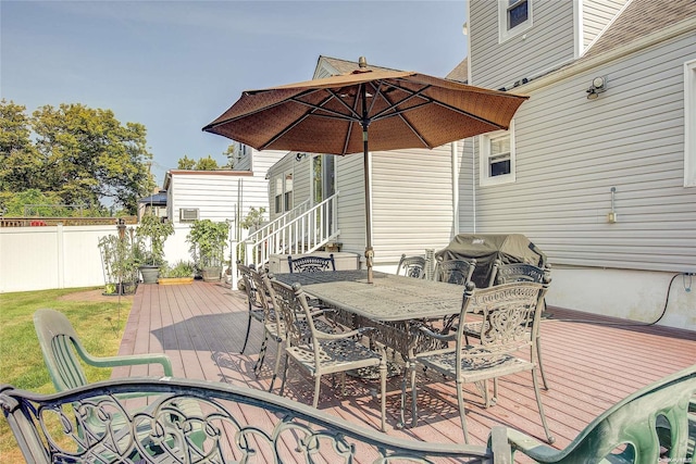 wooden deck featuring a grill