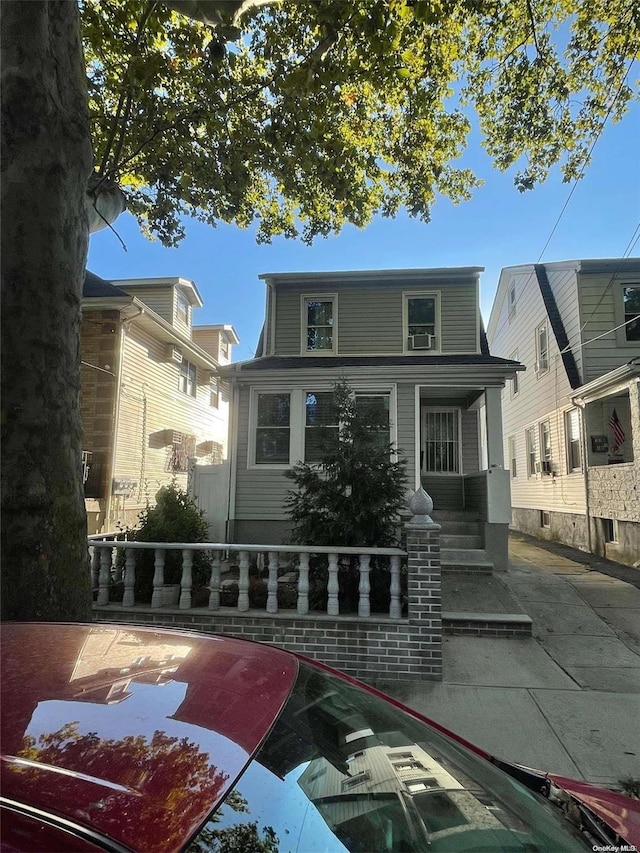 rear view of property with covered porch