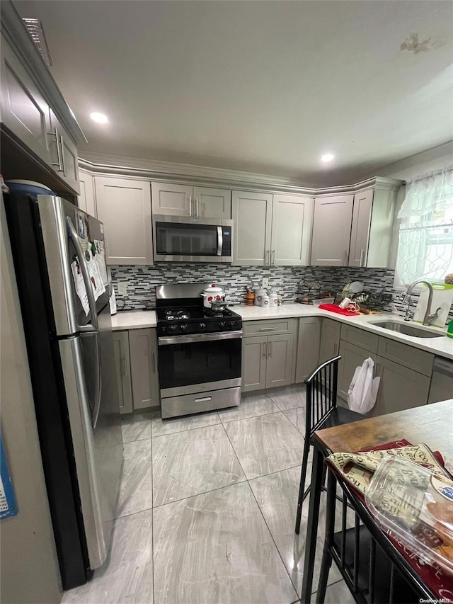 kitchen with stainless steel appliances, gray cabinets, and sink