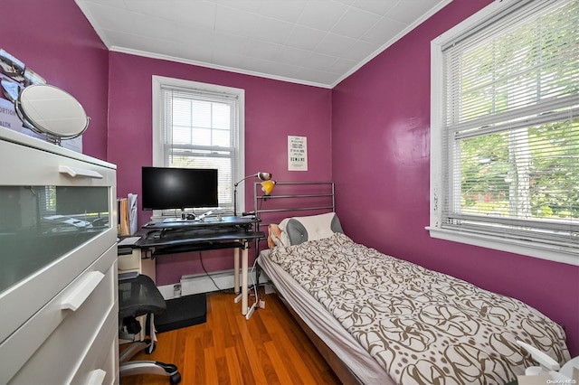 bedroom with hardwood / wood-style flooring and crown molding