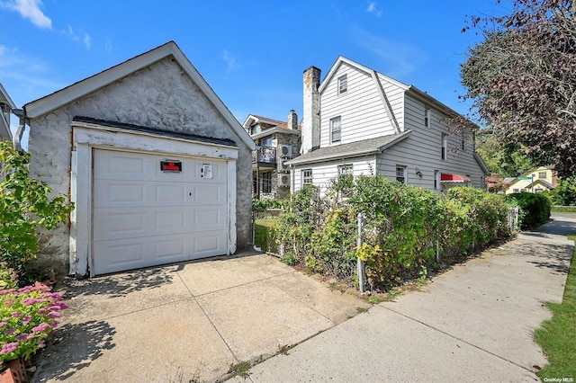 exterior space with an outbuilding and a garage