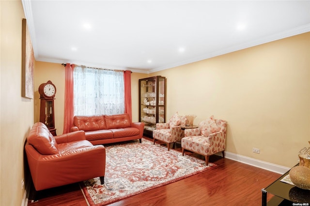 living room with wood-type flooring and ornamental molding