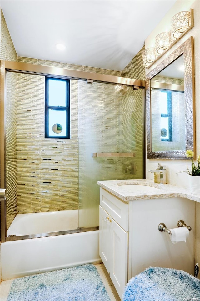 bathroom with vanity and enclosed tub / shower combo