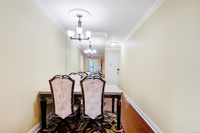 dining area with ornamental molding, a notable chandelier, and wood-type flooring